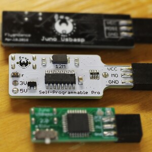 May include: Three small circuit boards, one black, one white and one green. The white board has the text "Self-Programmable Pro" printed on it. The green board has a small button on it.