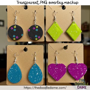 May include: A display of handmade earrings in various shapes and colors. The earrings include black circles with star patterns, lime green diamonds, teal teardrops, and purple hearts. Each pair hangs on a brown display card with silver hooks. The text "Transparent PNG overlay mockup" is at the top.