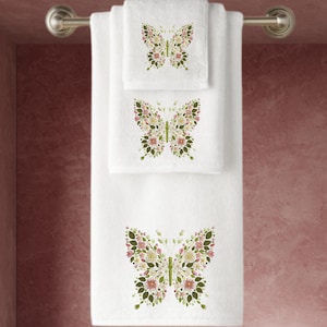 May include: White bath towels with embroidered floral butterfly designs. The butterflies are in shades of pink, green, and white.