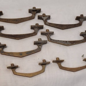 May include: A set of eight vintage brass cabinet door pulls with a simple, mid-century modern design.