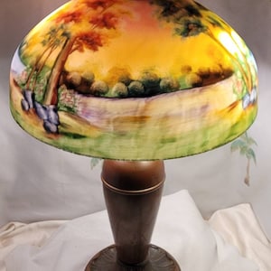 1910s Art Nouveau, reverse painted lamp, in the Jefferson style, with two tone bronze base.