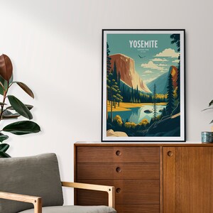May include: A framed poster with a vintage travel illustration of Yosemite National Park. The poster features a mountain range, a lake, and a forest. The text "Yosemite National Park" is printed in white on a blue background.