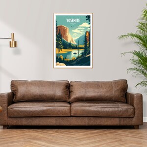 May include: A brown leather sofa with two cushions in front of a white wall with a framed poster of Yosemite National Park. The poster features a mountain range, a lake, and trees. A potted plant is on the right side of the sofa.