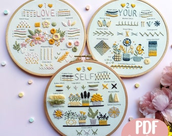 Puede incluir: Tres aros de bordado con tela azul claro y marcos de madera. Cada aro presenta un diseño floral diferente con varios puntos de bordado. Los aros están etiquetados con "I Love", "Your" y "Self" con los nombres y los números de los puntos correspondientes. El texto "PDF Level 1,2,3" es visible en la esquina inferior derecha.