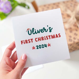 Personalised Baby&#39;s First Christmas Card, Santa Hat Design