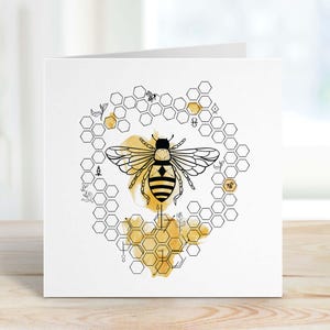 May include: A black and white illustration of a bee with a honeycomb pattern in the background. The bee is surrounded by a watercolor wash of yellow and gold.