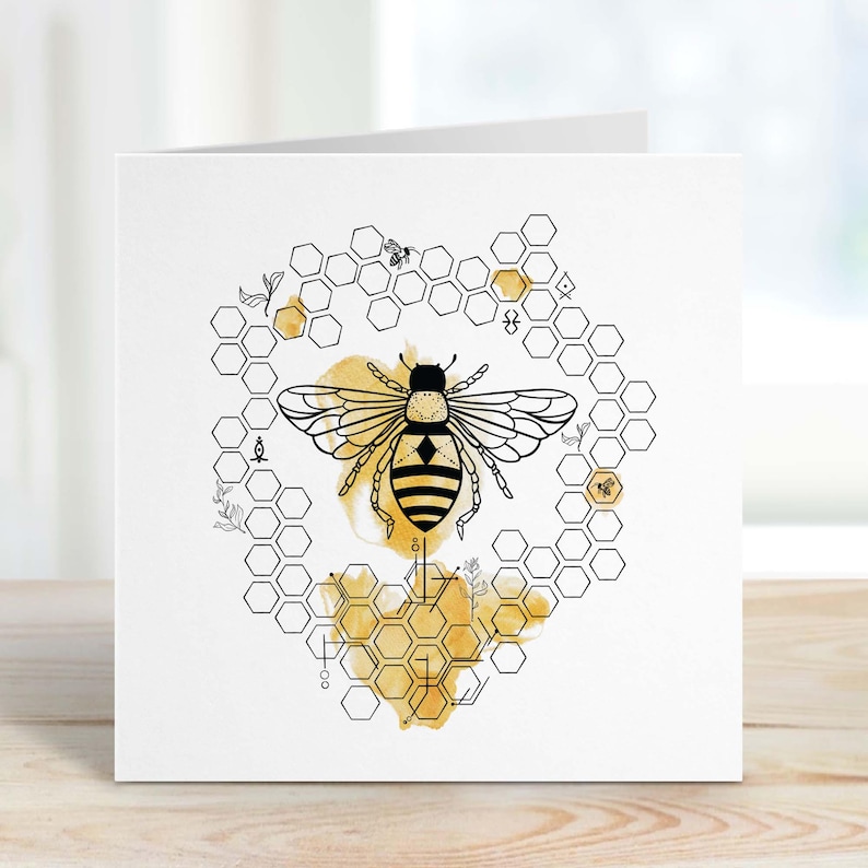 May include: A black and white illustration of a bee with a honeycomb pattern in the background. The bee is surrounded by a watercolor wash of yellow and gold.