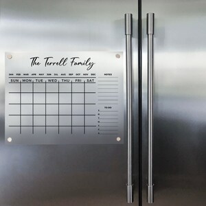 May include: A white dry-erase calendar with the text "The Terrell Family" at the top. The calendar has spaces for each month of the year, days of the week, notes, and a to-do list.
