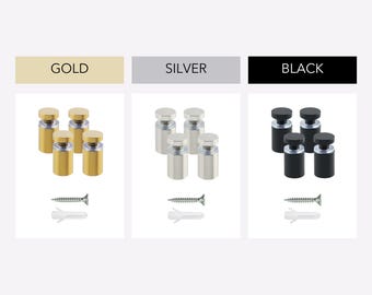 May include: A set of four cylindrical sign standoffs with matching screws and wall anchors, presented in three color options labeled as GOLD, SILVER, and BLACK. Each standoff features a flat circular cap and a threaded metal body.