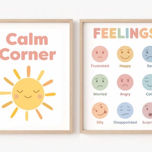 May include: Two framed prints with a calming theme. The left print features a yellow sun with a smiling face and the text "Calm Corner". The right print has the text "FEELINGS" and features nine colourful circles with different facial expressions, each labelled with a feeling word.