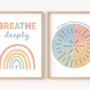 May include: Two framed prints with a pastel rainbow and the words "BREATHE deeply" on the left and a wheel of emotions with the text "It's okay to feel your feelings." on the right.