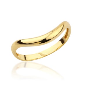 May include: A simple gold band ring with a curved, slightly rounded shape.