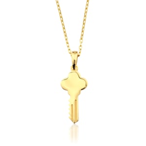 May include: A gold-colored key pendant necklace. The key pendant has a rounded top and a detailed key bit. The necklace chain is also gold-colored and delicate. The key pendant is a symbol of new beginnings.