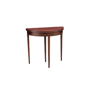 May include: A half-moon shaped, mahogany-colored table with three slender legs. The table has a decorative inlaid border around the curved edge. The legs are tapered and have a lighter wood accent. A classic piece of furniture.