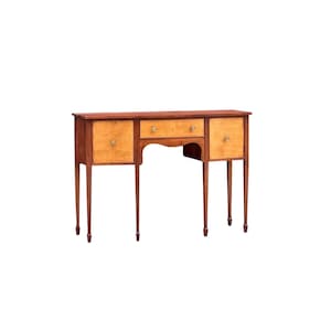 May include: A wooden console table featuring a dark brown frame and four slender legs. The piece includes a central drawer and two side cabinets, all finished with lighter tan panels and small, round, metallic knobs on each drawer and door front.