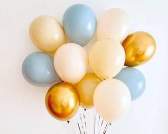 Könnte beinhalten: Ein Bündel Ballons in den Farben Blau, Gold und Creme. Die Ballons sind mit Schnüren zusammengebunden.