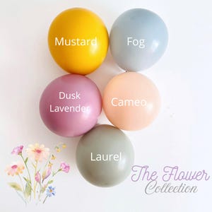 May include: Five round balloons in mustard, fog, dusk lavender, cameo, and laurel colours are displayed. Each balloon has a colour name written on it. The Flower Collection text is in the bottom right corner, and a floral graphic is in the bottom left corner.