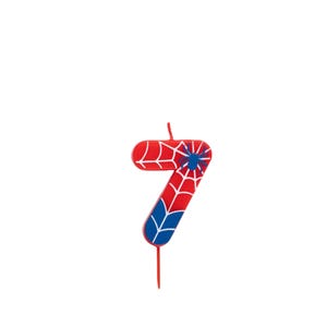 May include: A red, white, and blue number 7 birthday candle with a spiderweb design and a blue spider. The candle has a wick at the top and a stick at the bottom.