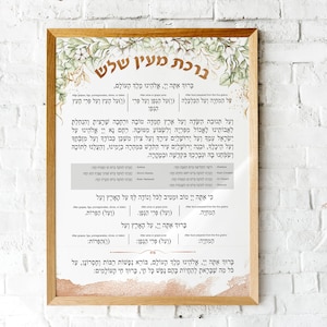 Puede incluir: Una impresión de arte de pared imprimible con un fondo de acuarela que presenta un diseño floral en tonos verdes y dorados. La impresión presenta texto hebreo en una fuente marrón, incluidas las palabras "ברכת מעין שלש" (que significa "Bendición del pozo de los tres") y una bendición judía tradicional.
