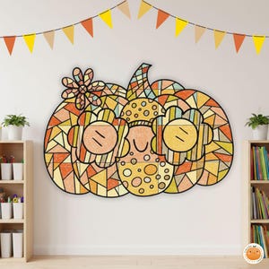 May include: A large, colorful pumpkin wall decoration with a mosaic-like design. The pumpkin is primarily orange, yellow, and brown, with a smiling face and flower accents. A string of festive pennant flags hangs above.