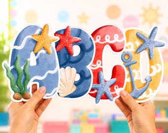 May include: Colorful ABC letters with a nautical theme. The letters are decorated with starfish, seashells, and an anchor. The letter A is blue with seaweed, B is blue with a seashell, C is red, and D is yellow.