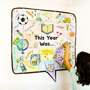May include: A colorful, hand-drawn artwork in the shape of a speech bubble, titled "This Year Was...". The artwork features various illustrations, including a soccer ball, school bus, globe, and owl, with words like "Fun", "Happy", and "Strong".