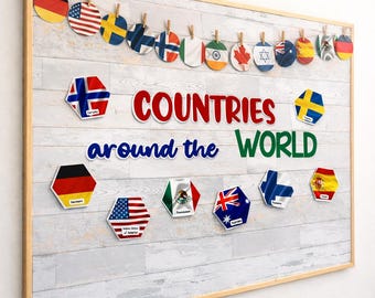 May include: A wooden framed bulletin board with the words "COUNTRIES around the WORLD" in red, blue, and green. The board displays country flags in various shapes and sizes, including circles and hexagons, attached with small wooden clips.