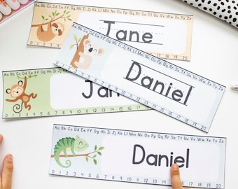 May include: Three printable name tags with a jungle theme. Each tag features a different animal: a sloth, a koala, and a chameleon. The tags include a line for writing a name and a number line from 0 to 20.
