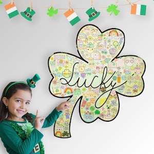 May include: A large four-leaf clover shaped poster featuring the word Lucky in black cursive script. The clover is filled with various colorful hand-drawn illustrations including rainbows, hearts, stars, books, and food items on a light background.