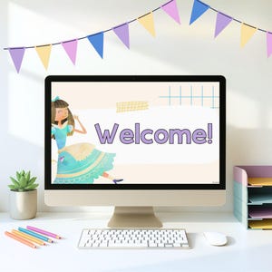 May include: A desktop computer displays a "Welcome!" message with a cartoon illustration of a girl in a blue dress. The desk has a keyboard, mouse, pencils, a succulent plant, and a multi-tiered paper organizer. A banner of colorful pennants hangs above.