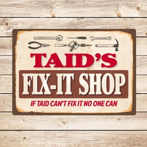 May include: A rusty metal sign with a brown background and white lettering. The sign reads "Taid's Fix-It Shop" with the words "Taid's" in red. The sign also has a slogan: "If Taid can't fix it no one can". The sign is decorated with various tools, including a wrench, pliers, a drill, and a hammer.