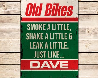May include: A green and red metal sign with the text "Old Bikes" in white. The sign says "Smoke a little, shake a little & leak a little. Just like... Dave."