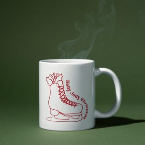 May include: White ceramic mug with a red illustration of an ice skate with holly on top. The text "Holly Jolly Christmas" is written on the mug.