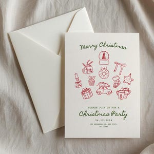 May include: A white card with a red and green Christmas party invitation. The card features a red illustration of a Christmas tree with ornaments, gifts, and other festive symbols. The text reads "Merry Christmas" and "Please join us for a Christmas Party" with the date and address below.