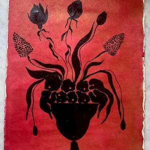 May include: A rectangular piece of paper with a deckled edge featuring a black ink illustration of a floral arrangement in a pedestal vase against a vibrant red and orange gradient background. The artwork depicts stylized flowers and leaves.