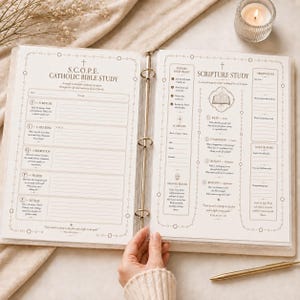 May include: An open three-ring binder featuring printed S.C.O.P.E. Catholic Bible Study and Scripture Study worksheets on white paper. The pages include structured sections for scripture, catechism, observation, prayer, and reflection.