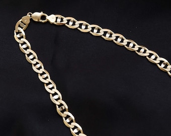 May include: A gold chain necklace with a curb link design. The chain is made of a thick, durable metal and has a polished finish.