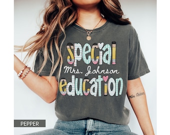 May include: Pepper-colored t-shirt with the words "special education" in a colorful, playful font. The text includes the name "Mrs. Johnson" and pencil and heart graphics. The shirt is a comfortable, casual style.