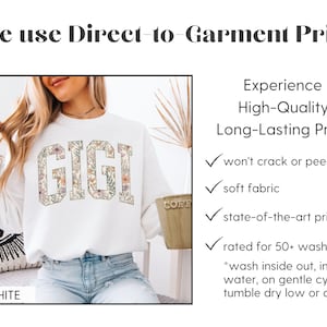 May include: A white sweatshirt featuring the word "GIGI" in a floral design. The image includes text about direct-to-garment printing, emphasizing features like soft fabric and durable prints. The sweatshirt is white.