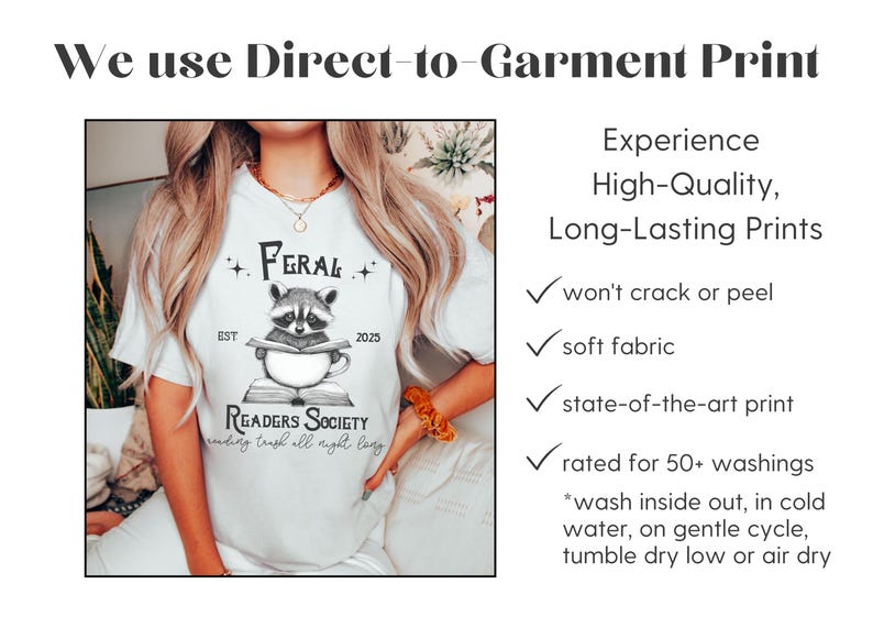 May include: White t-shirt with a black and white illustration of a raccoon reading a book. The text on the shirt reads "Feral Readers Society" and "reading trash all night long".