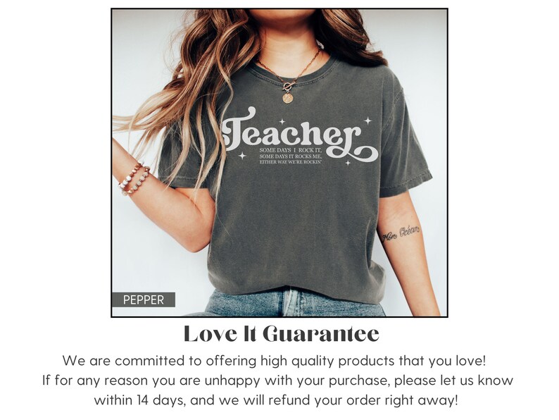 May include: Dark grey t-shirt with the word "Teacher" in a white, stylized font. The shirt also features the text "Some days I rock it, some days it rocks me, either way you're rocked!" A casual, comfortable tee.
