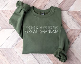 May include: A green sweatshirt with a white floral design and the text "GREAT GRANDMA" printed on the front.
