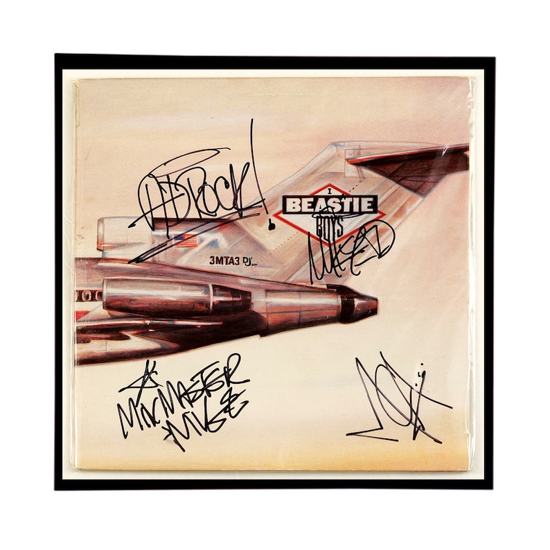 May include: A vintage vinyl record album cover featuring a plane with the text "BEASTIE BOYS" and the album title "Licensed to Ill" in a diamond shape. The album cover is signed by the band members: "Ad-Rock", "Mike D", "MCA", and "Yauch".