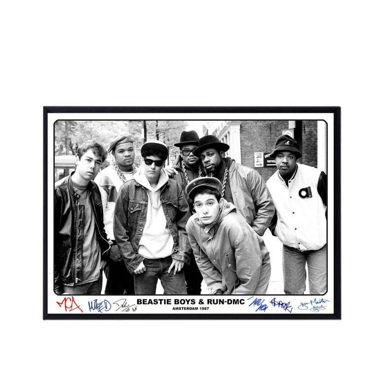 May include: Black and white photo of the Beastie Boys and Run-DMC posing together in Amsterdam in 1987. The photo is signed by all five members of the groups. The text "BEASTIE BOYS & RUN-DMC AMSTERDAM 1987" is printed below the photo.