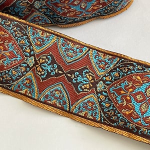 May include: A brown, blue, and gold patterned trim with a paisley design.
