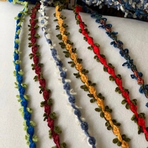 May include: Five different colors of trim with a flower design. The trim is made of a soft, fuzzy material and is perfect for adding a touch of elegance to any project.