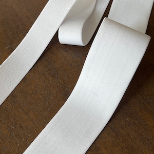 May include: White elastic band, a type of fabric used for sewing and crafting projects.