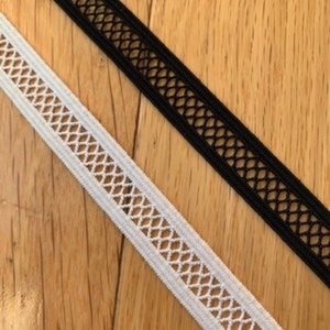 May include: Two pieces of elastic trim with a diamond-shaped mesh pattern. One piece is white and the other is black.
