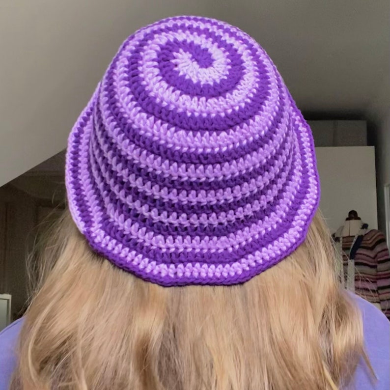 May include: A purple and lavender striped crocheted bucket hat.