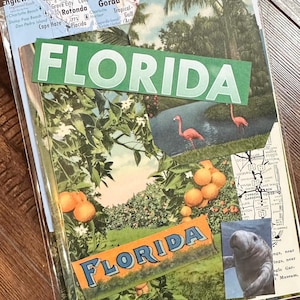 May include: A collage of vintage Florida postcards. The postcards feature images of flamingos, orange groves, and a manatee. The word "FLORIDA" is prominently displayed in green and orange text. The collage is encased in a clear plastic sleeve.